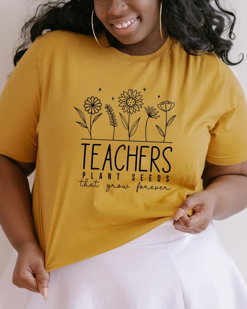 Front of a model wearing a size Large Teachers Plant Seeds That Grow Forever in Mustard by Simply Sage Market. | dia_product_style_image_id:281578